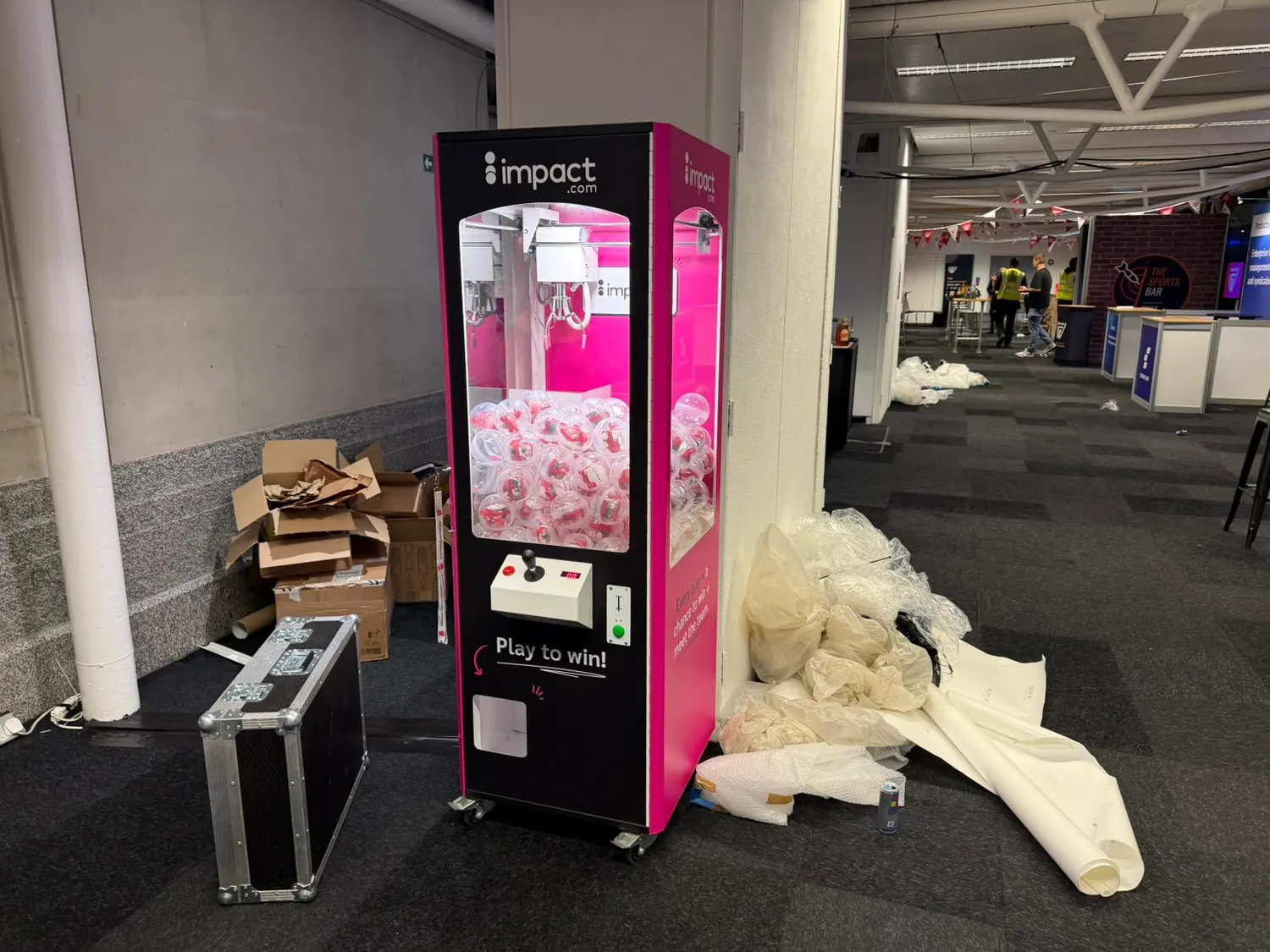 Branded claw machine filled with teddy bear prizes