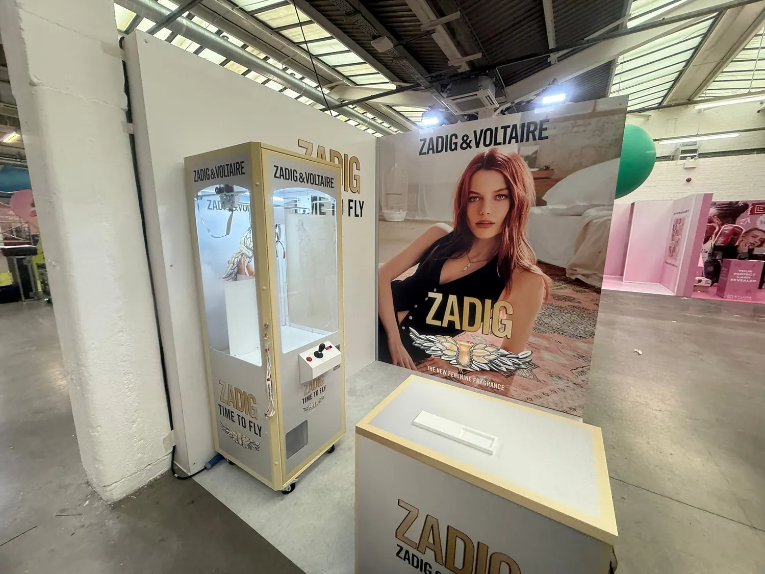 Gold branded claw machine at a retail launch
