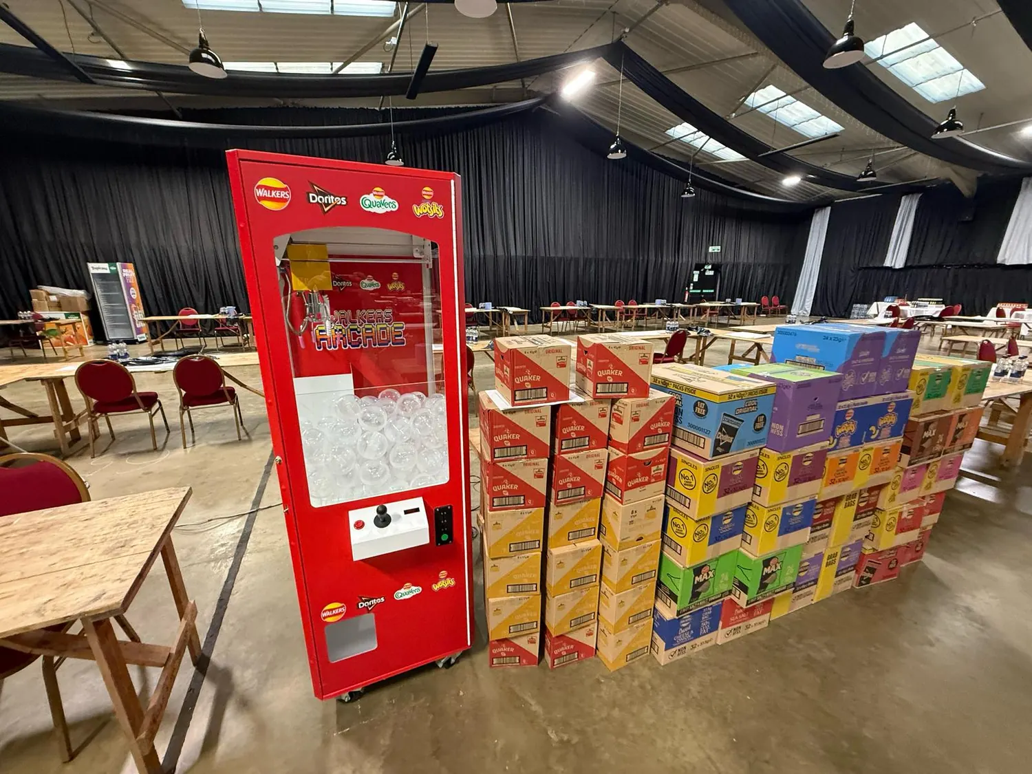 Prize crane stocked with branded prizes at a corporate event