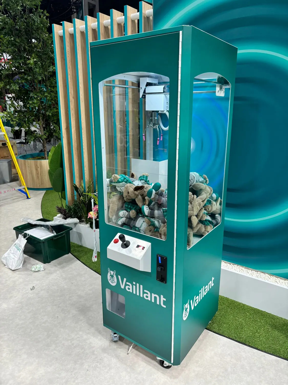Teal branded prize crane at a trade show